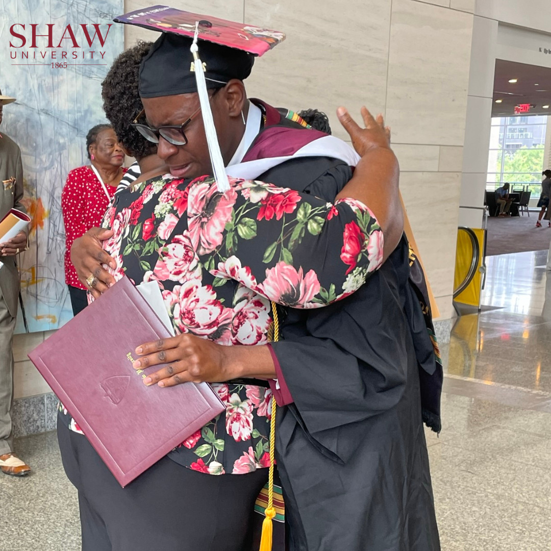Dave Walters Jr. hugging mother, Vanessa Barnes-Hammond, in cap and gown